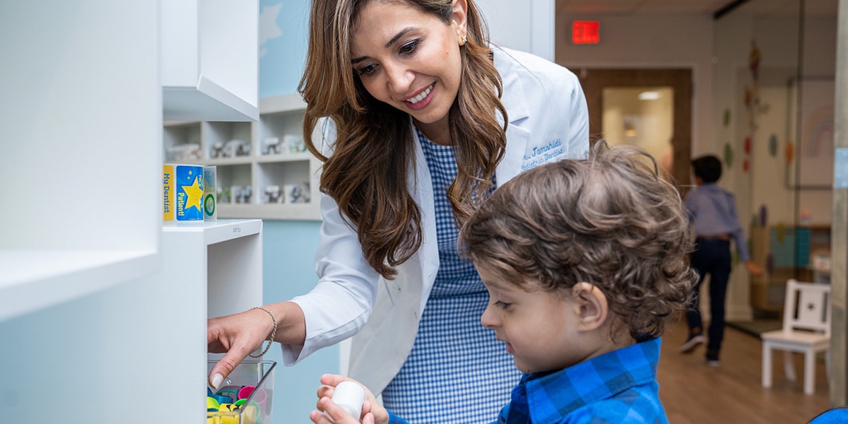 Dr. Jamshidi helping patient pick out toy