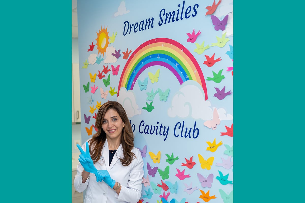 Dr. Jamshidi in front of No Cavity Club wall