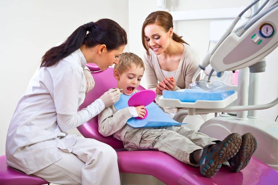child in dentist office getting check up
