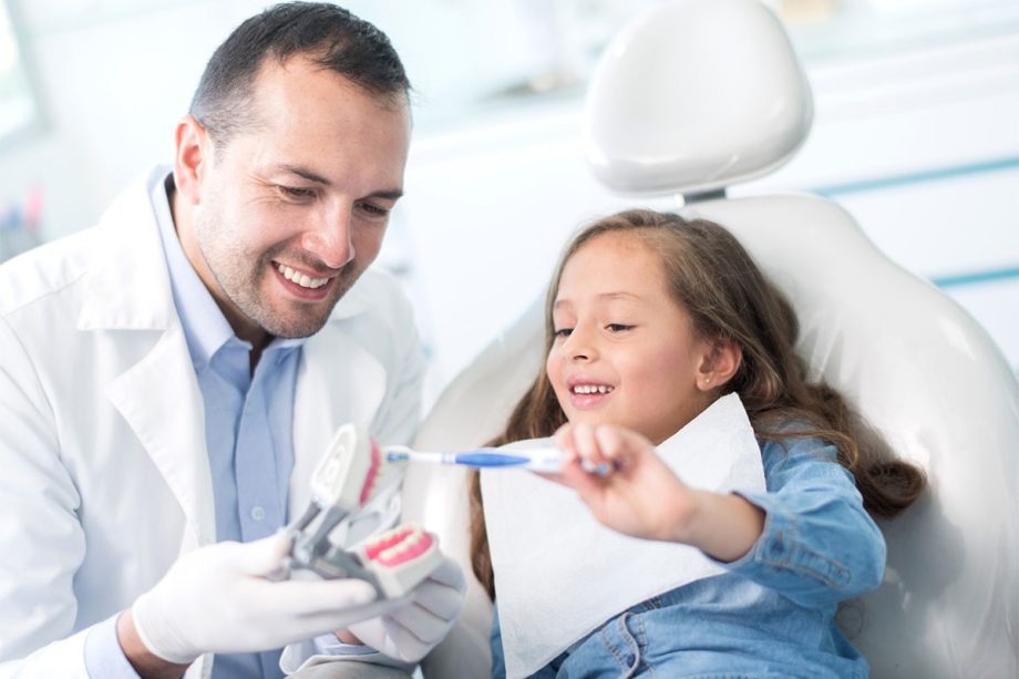Dentist with child teaching cleaning image