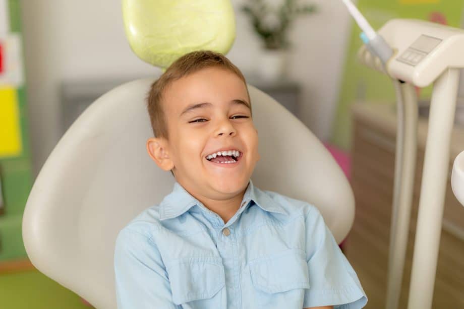 boy laughs in dental chair